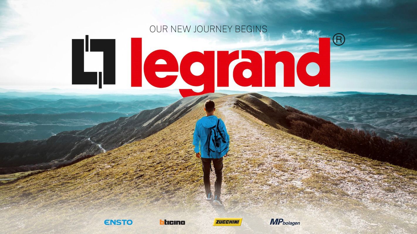 Man walking on a mountain towards Legrand logo.